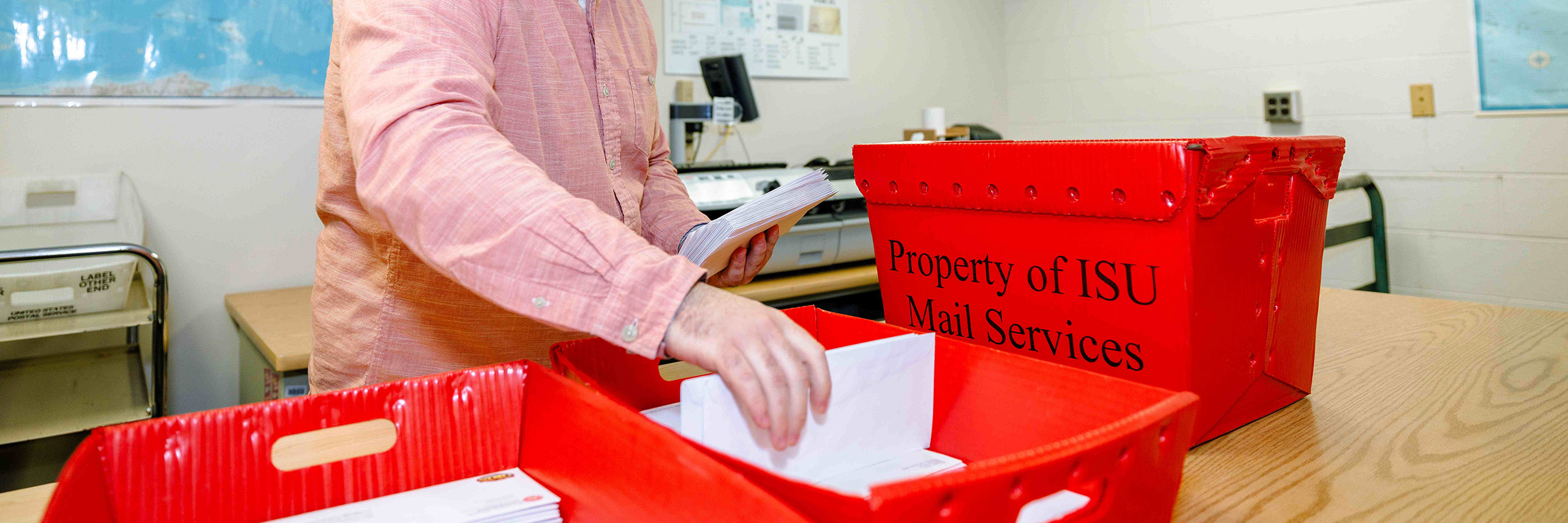 Employees are sorting and separating mail at the mail services